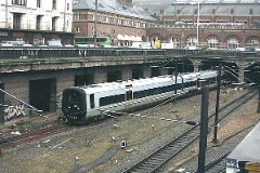 The "Øresundstog" trainset photographed in Copenhagen 27. November 2003.  The trainset is built by Adtranz, Sweden (Bombardier Transportation). It is purchased in corporation between SJ, Sweden and DSB, Denmark. The trainsets are in operation between Sjælland in Denmark and southern Sweden via the bridge over Øresund. Each unit consists of 3 coaches. The trainsets was put in service in 2000 - 2002. Electric. 2.120 kW. Max speed 180 km/h - 112 mph. Length 78 900 mm. Weight 153 metric tonnes. 20 seats 1st class, 217 seats 2nd class. Up to 5 trainsets can be put together.